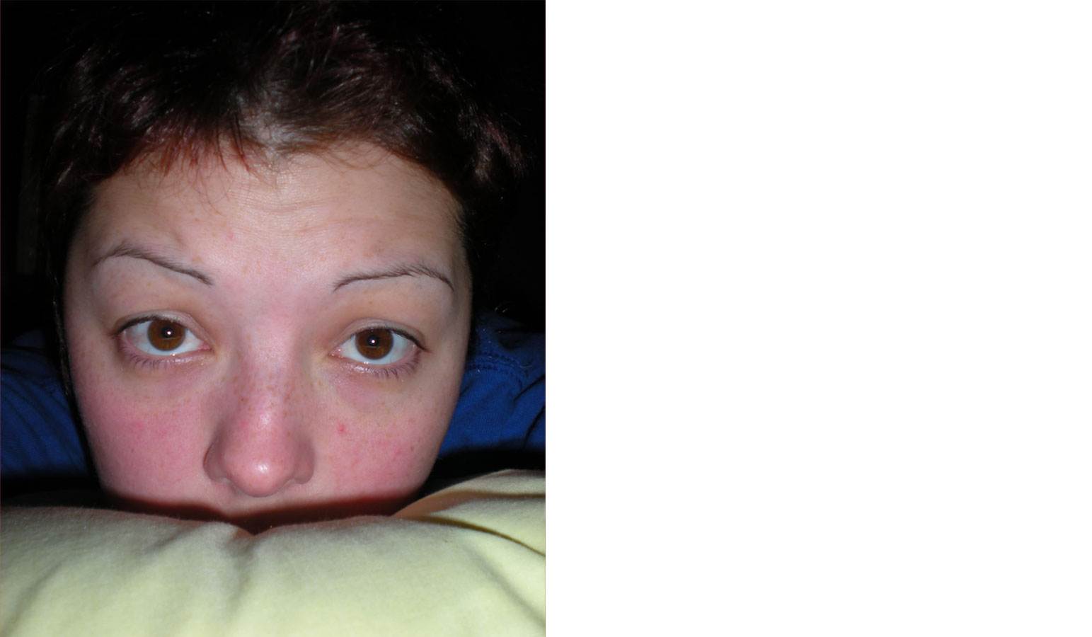 Een meisje ligt op bed met haar billen omhoog.